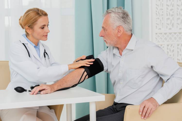 doctor-placing-blood-pressure-cuff